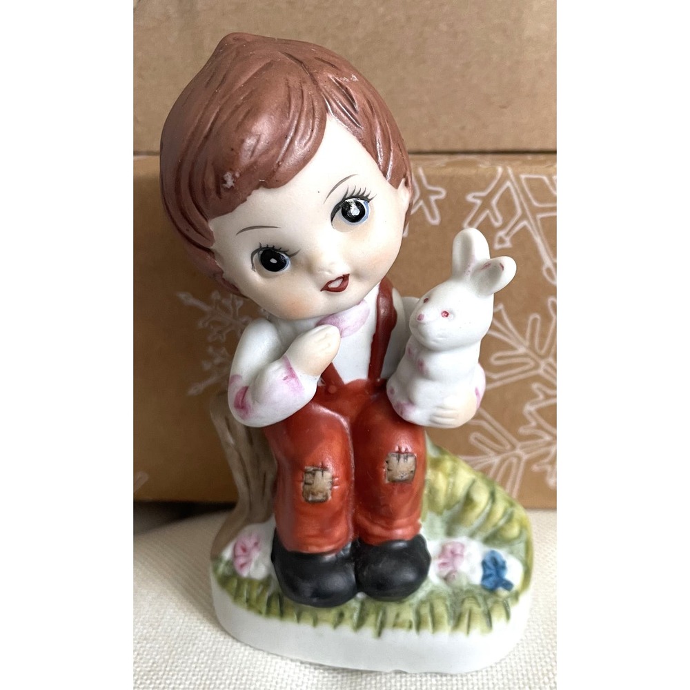 Vintage porcelain big eyed little girl holding small bunny and sitting on stump